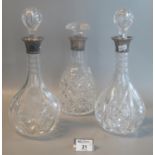 Pair of cut glass decanters together with a mallet shaped decanter all with stoppers and silver