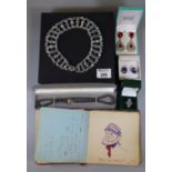 A collection of silver and costume jewellery and an autograph book. (B.P. 21% + VAT).