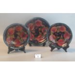 Pair of Moorcroft Art Pottery 'Pomegranate' shallow dishes or plates together with a similar