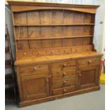 Modern pine two stage rack-back kitchen dresser with fitted spice drawers, and an arrangement of