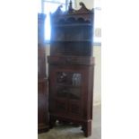 Late Victorian oak heavily carved, ornate standing corner cabinet with shaped oak shelves to the