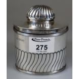 Georgian style silver fluted tea caddy of oval form by Herbert C Lambert, Coventry Street, London.