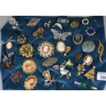 Box of vintage costume brooches to include cameos, filigree buttery, other butterflies, Christmas