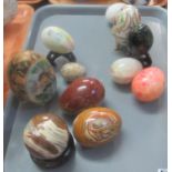 Collection of mainly hard stone specimen eggs, together with an Continental porcelain egg and