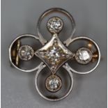 An early 20th century diamond brooch, the stones set in a cross within a platinum fronted yellow