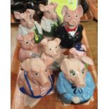 Tray of eight Wade Pig money banks, all with their stoppers and a framed NatWest leaflet,