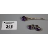 A pair of amethyst and silver screw back earrings and a brooch. (B.P. 21% + VAT)