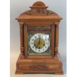 Early 20th century walnut three train architectural mantel clock with German movement, striking on