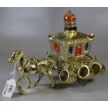 Small gilt ceramic stagecoach decanter with royal crown stopper and gilt horse, surrounded by six