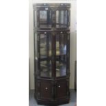Modern hexagonal glazed two section metal mounted display cabinet with blind cupboard below. (B.P.