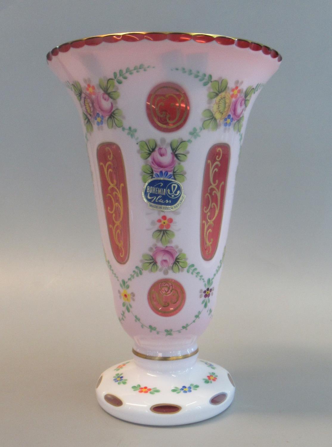 A Bohemian overlay glass flared vase overall with ruby and gilt hand painted floral and foliate