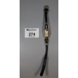 Ladies small 9ct gold Cyma wrist watch with rectangular Arabic face on a leather cord strap. 10g