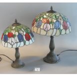 Two similar reproduction Tiffany style mushroom lamps with lead glazed shades on bronzed bases. 47cm