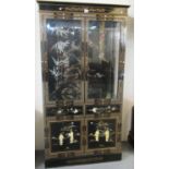 Chinese style lacquered and gilded two door display cabinet with glass shelves to the interior