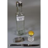 Silver topped glass bottle together wit ha collection of silver items to include: engine turned