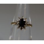 A 9ct gold oval sapphire and diamond cluster ring. Ring size I. Approx weight 1.7g. (B.P. 21% + VAT)