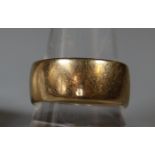A wide 9ct gold wedding ring. Ring size T. Approx weight 10.g. (B.P. 21% + VAT)