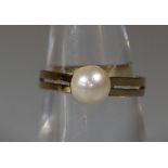 A 9ct gold cultured pearl ring. Ring size P. Approx weight 2.2g. (B.P. 21% + VAT)