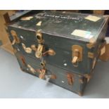 Two large metal trunks with metal locks and leather handles both with the name 'F Travers -