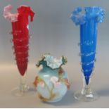 Two similar coloured glass trumpet tapering vases, together with a globular vaseline art glass vase,