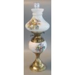 20th century double oil burner lamp having opaline glass floral shade and reservoir on a brass base.