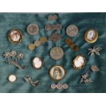 A collection of brooches including four shell cameo brooches and a Victorian, ?Mother? brooch. (B.P.