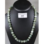 A string of green hard stone beads. (B.P. 21% + VAT)
