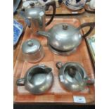 A Liberty's 'Tudric' beaten pewter breakfast set, to include: tea pot and glass bottomed stand,