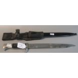 German military Puma bayonet, with single edge fullered blade, chequered grip, metal scabbard and