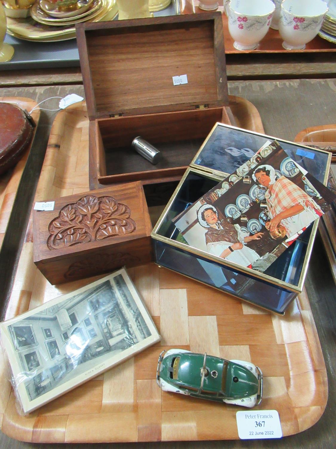 Two carved sandalwood boxes, a glass casket with postcards and a Schuco wind-up Volkswagen car