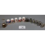 A collection of thimbles including four silver thimbles, five Singer sewing machine thimbles, a