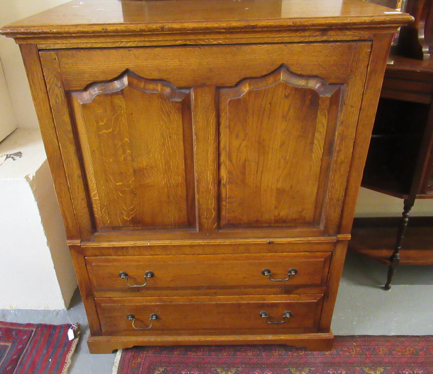 18th century style oak TV unit/cabinet having two ogee fielded panels above two drawers. (B.P. 21% +