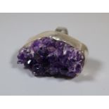 A silver ring set with a large piece of amethyst geode. Ring size Q. (B.P. 21% + VAT)