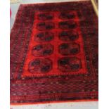 Large red and blue ground Middle Eastern design carpet with central medallions and stylised floral