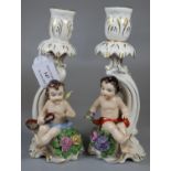 Pair of German porcelain cherub candlesticks. (B.P. 21% + VAT)