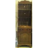 17th century style oak narrow shelving unit or dresser having blind panel cupboard to the base on