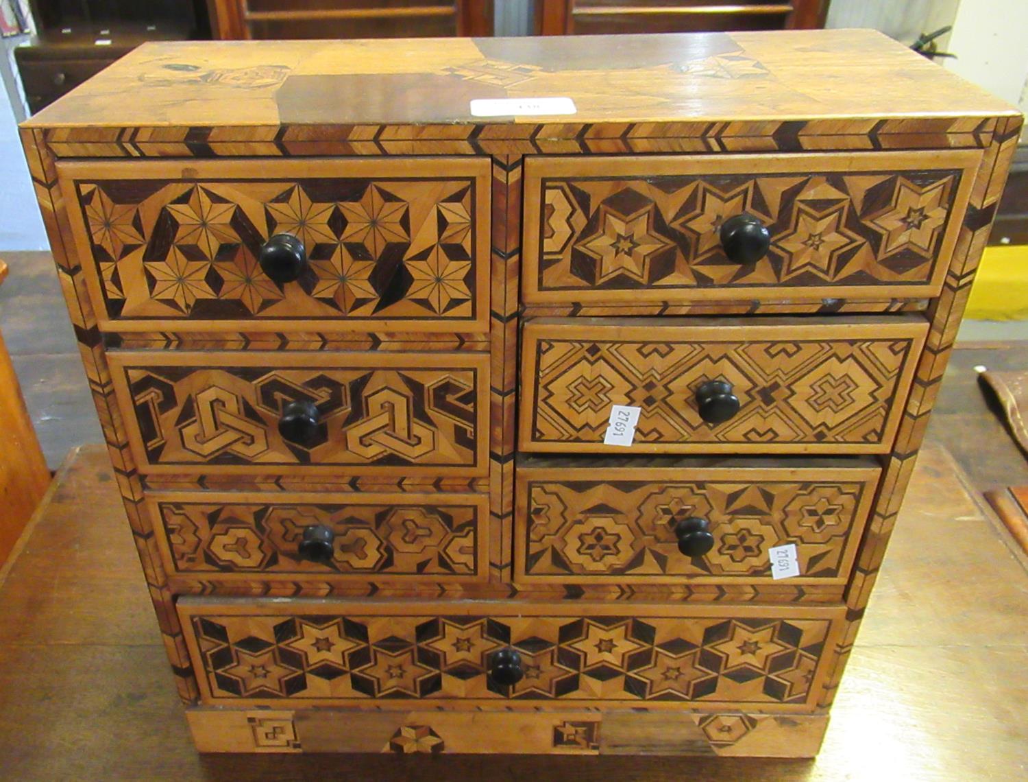 Japanese mixed woods parquetry table top bank of 7 drawers. (B.P. 21% + VAT)