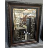 Engraved heavy bevelled glass mirror with scroll work decoration within a mahogany finish frame. The