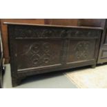 17th/18th century oak coffer having fitted candle box, the front panel with ornate carving, standing