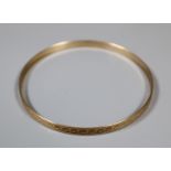 9ct gold engraved bangle. Approx weight 6g. (B.P. 21% + VAT)