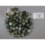 A string of green hardstone beads. (B.P. 21% + VAT) Report not carried out by a professional