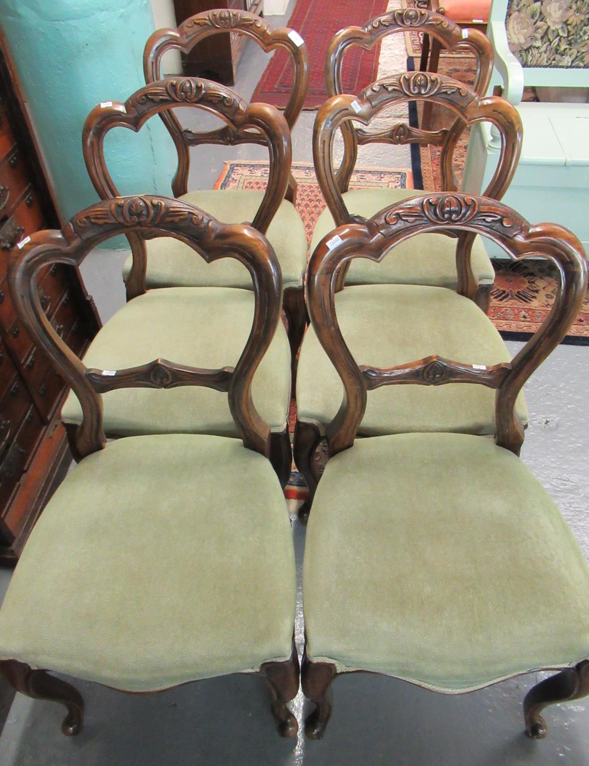 Set of six Victorian walnut balloon-back dining chairs with stuff-over seats on cabriole legs and