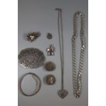 A collection of silver and white metal jewellery including a silver bangle, silver flattened curb