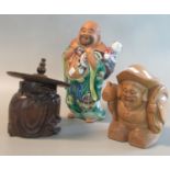 Carved wooden figure of a jovial man with large sack on his back, together with another Chinese