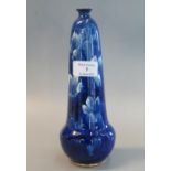 Late 19th/early 20th century Doulton Burslem Corolian ware tapering bud vase on a blue ground with