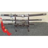 Set of 3 modern Japanese replica Samurai swords, to include Tanto, Wakazashi and a Katana on a