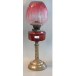 Early 20th century double oil burner lamp having cranberry fluted shade, cranberry glass reservoir