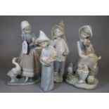 Four Spanish Lladro porcelain figurines to include young girl with geese, girl with puppy, girl with