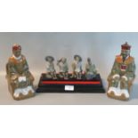 Pair of modern Chinese ceramic figures of seated deities, 21cm high, together with a group of 4