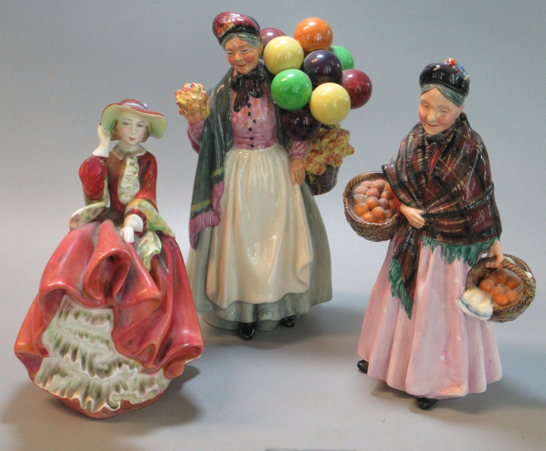 3 Royal Doulton bone china figurines to include, 'Top O' The Hill', 'The Orange Lady' and 'Biddy